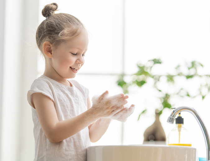 Little girl washing hands