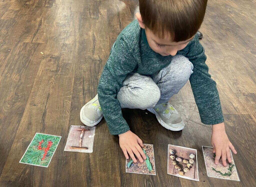 Child playing with number and letter cards