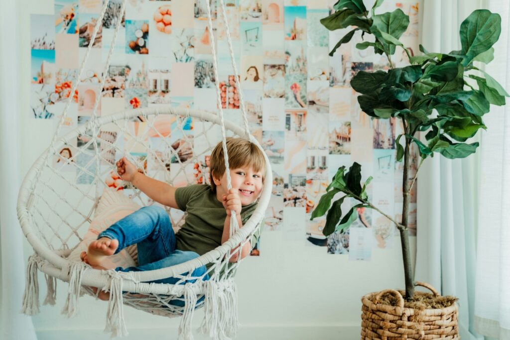 Little boy sitting in a net chair and smiling