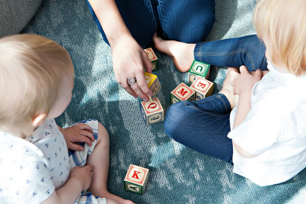 Mom and two children playing with blocks