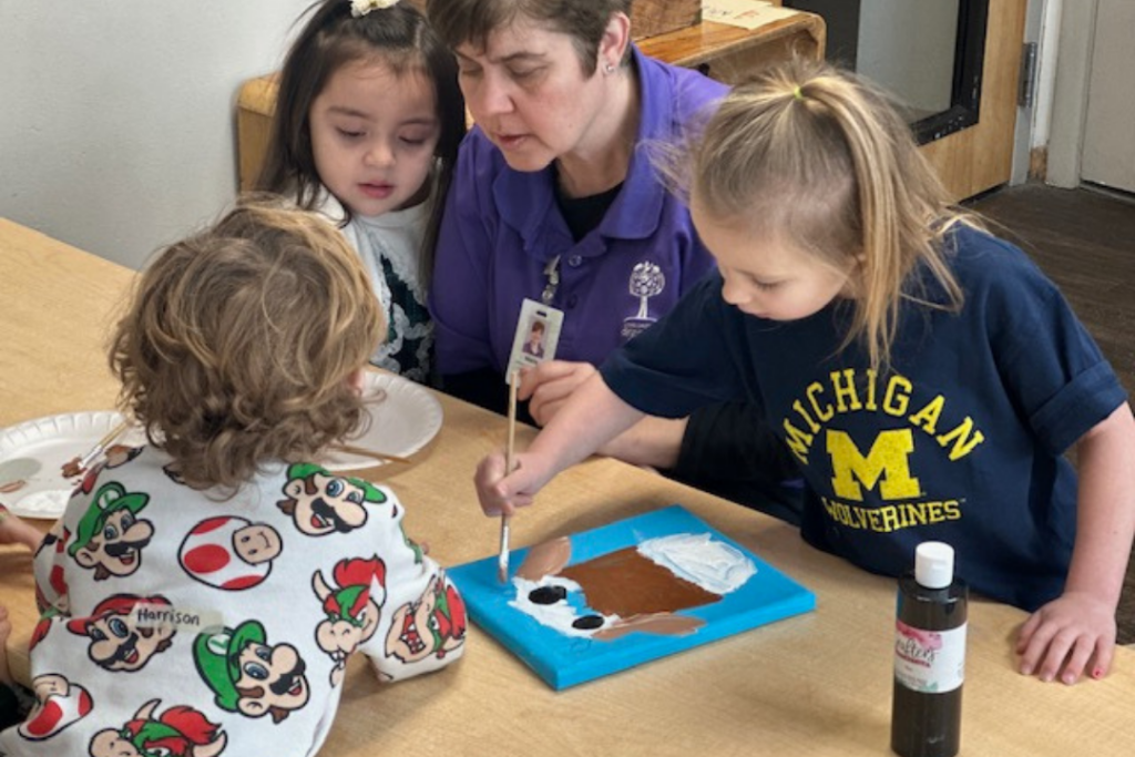 Teacher and students working on a project together