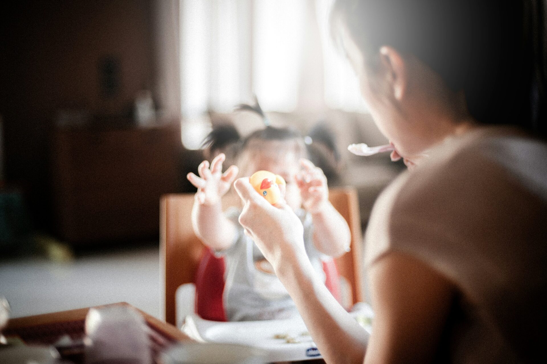 Mother feeding child as part of their routine.