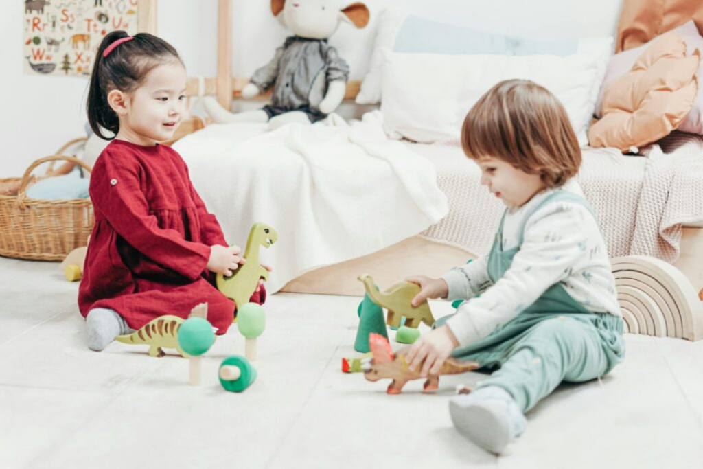 Young children playing and sharing toys during a preschool playdate.