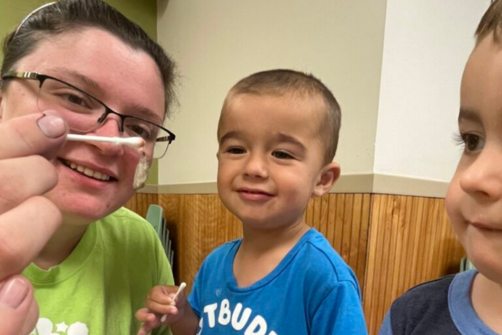 Toledo-area teacher and toddlers observing bugs in the classroom