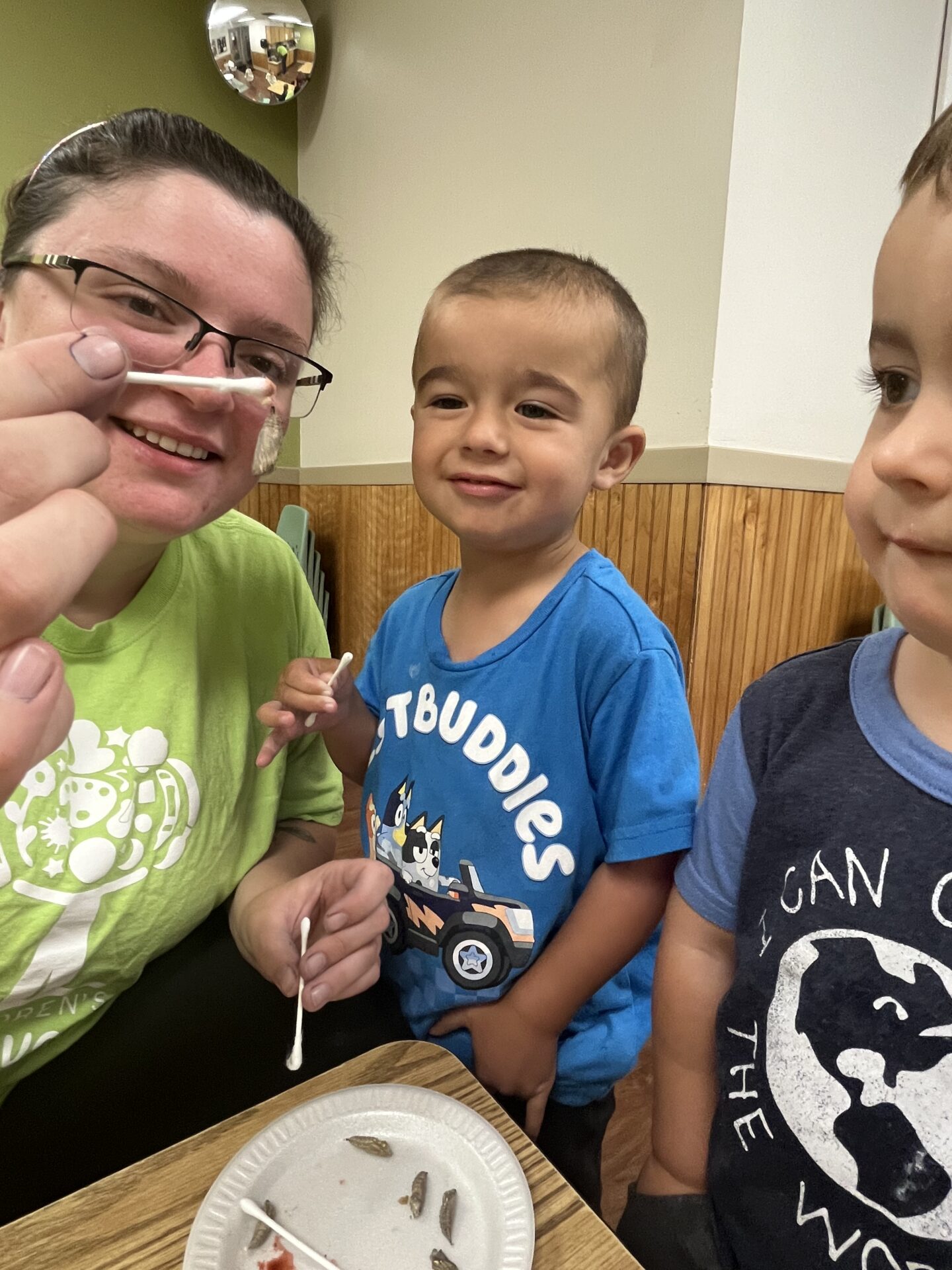 Toledo-area teacher and toddlers observing bugs in the classroom