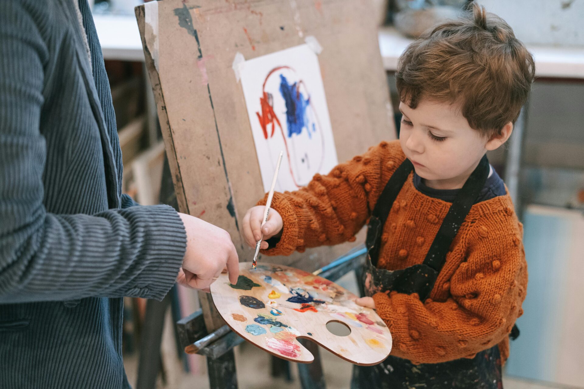 Child painting and learning through the Reggio Emilia approach.