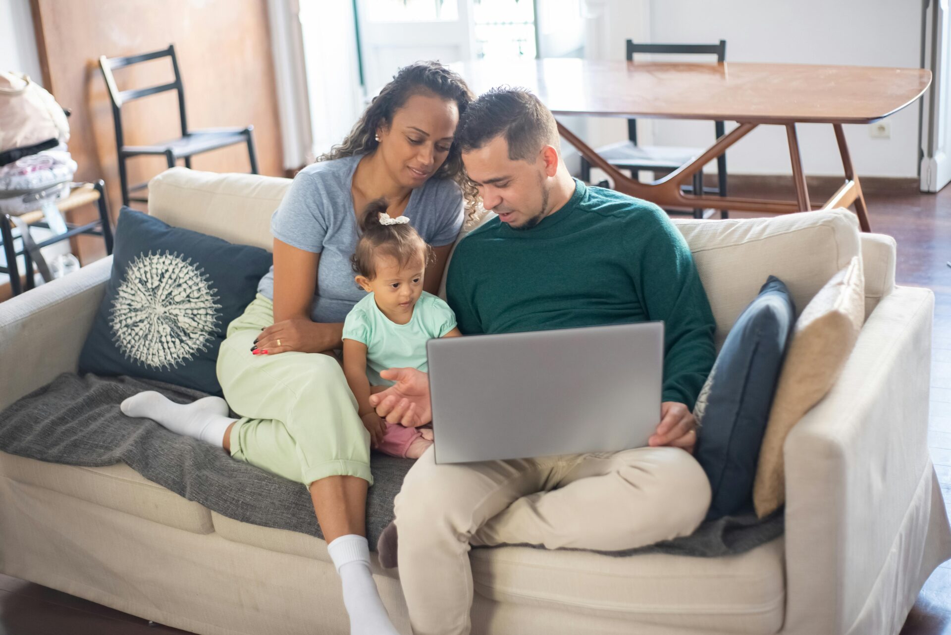 Working parents at home with their child.