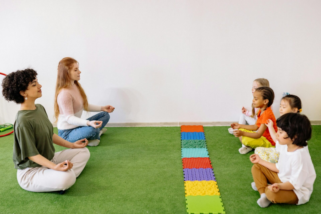 Early childhood educators and child enjoying a mindful moment together
