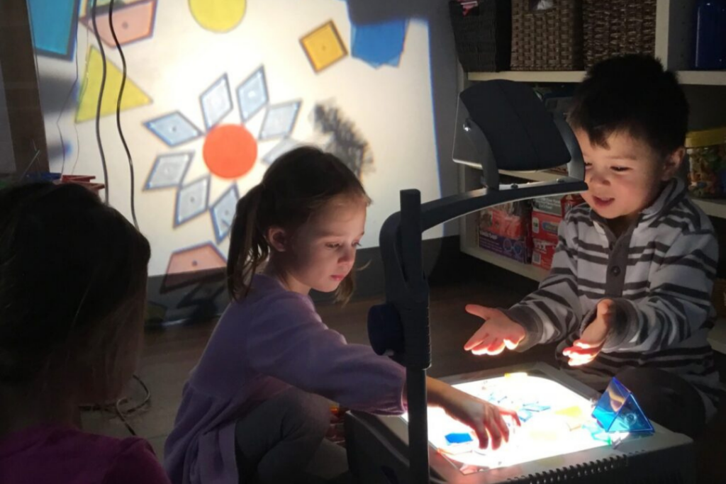 Toledo-area preschool students exploring a Reggio-inspired lesson on lights and shadows