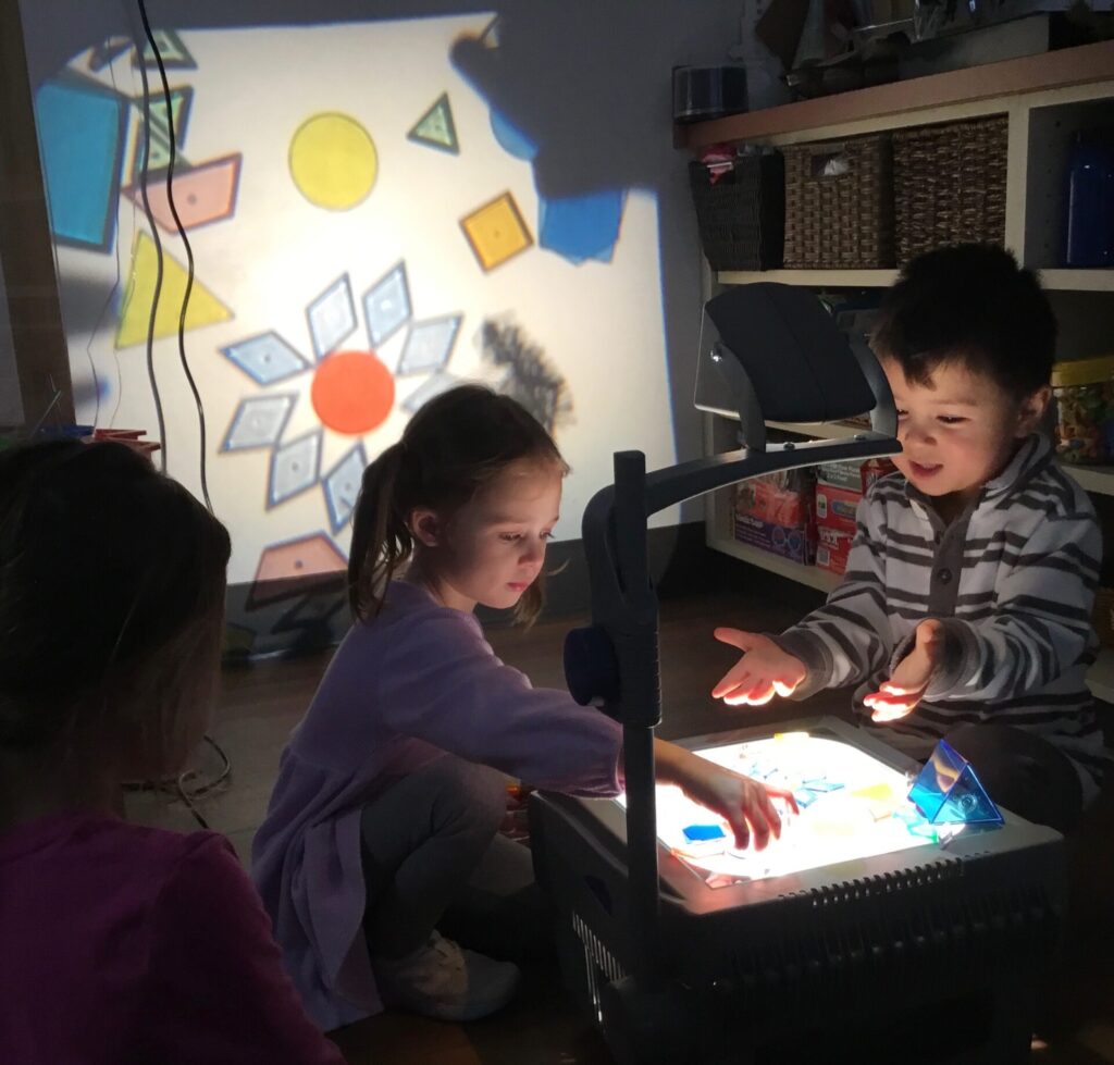 Toledo-area preschool students exploring a Reggio-inspired lesson on lights and shadows