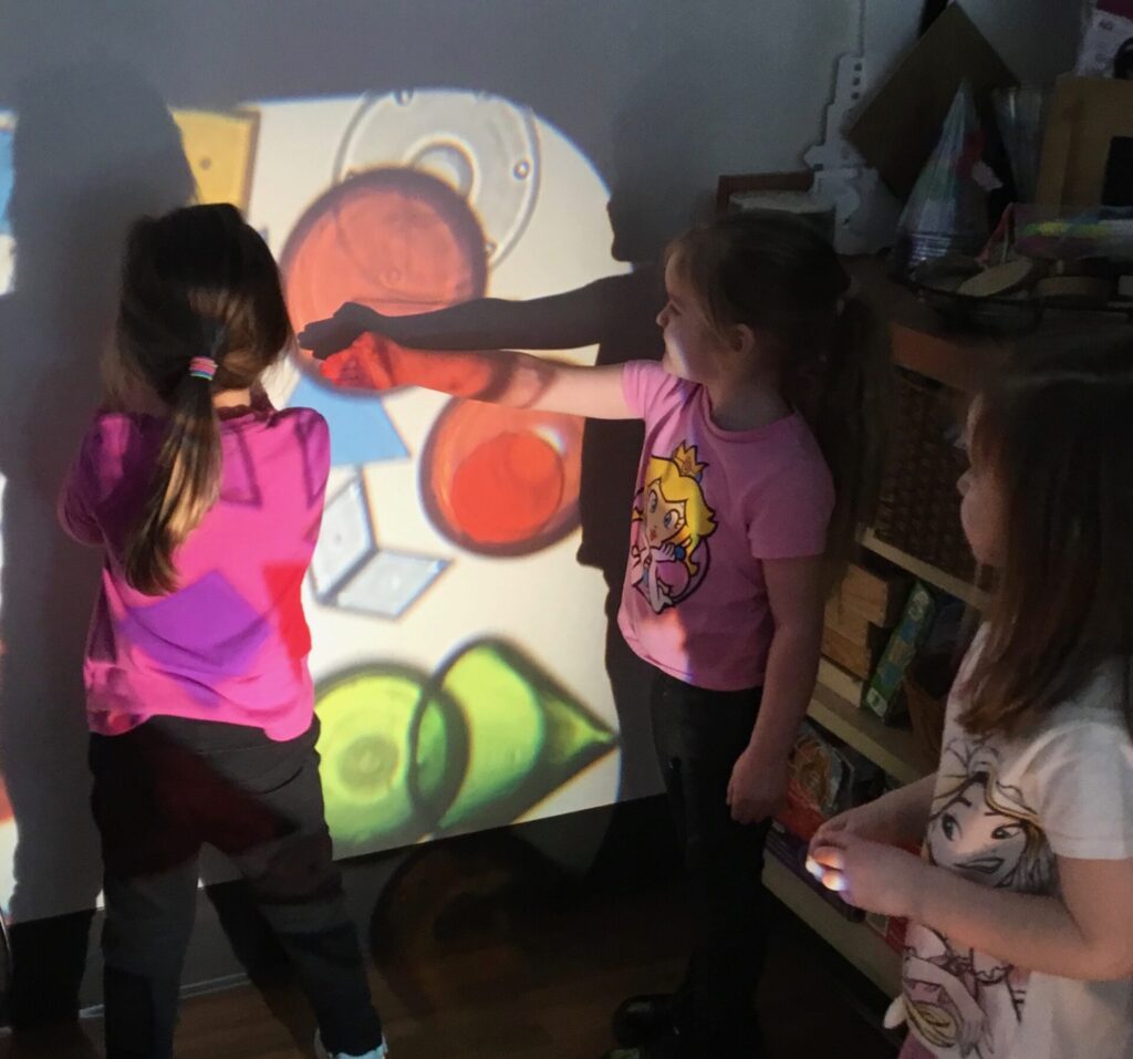 Toledo-area preschool students exploring a Reggio-inspired lesson on lights and shadows