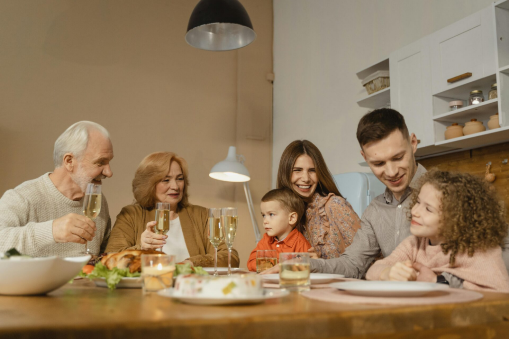 Family at the dinner table asking their preschool and day care students about their day.