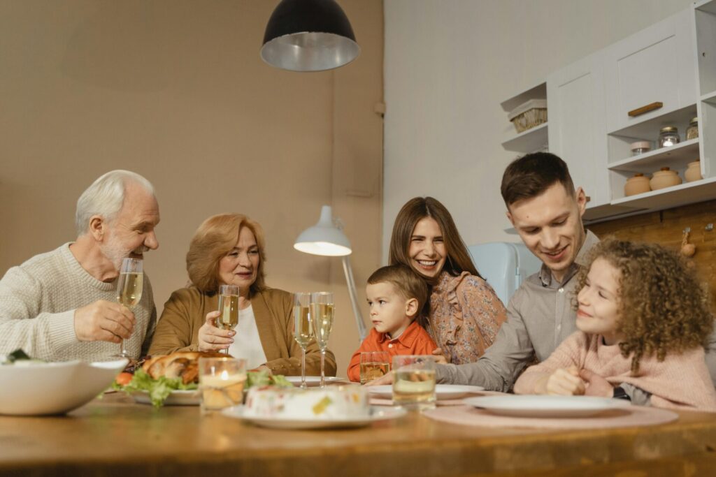 Family at the dinner table asking their preschool and day care students about their day.

