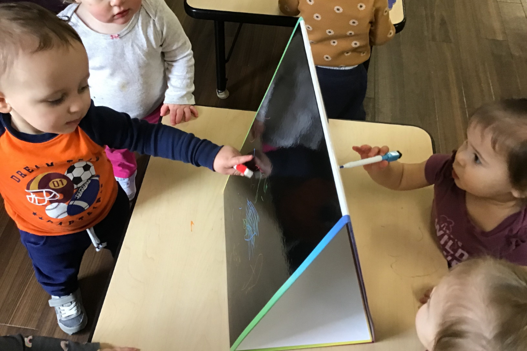 Toledo toddler program students painting for Week of the Young Child
