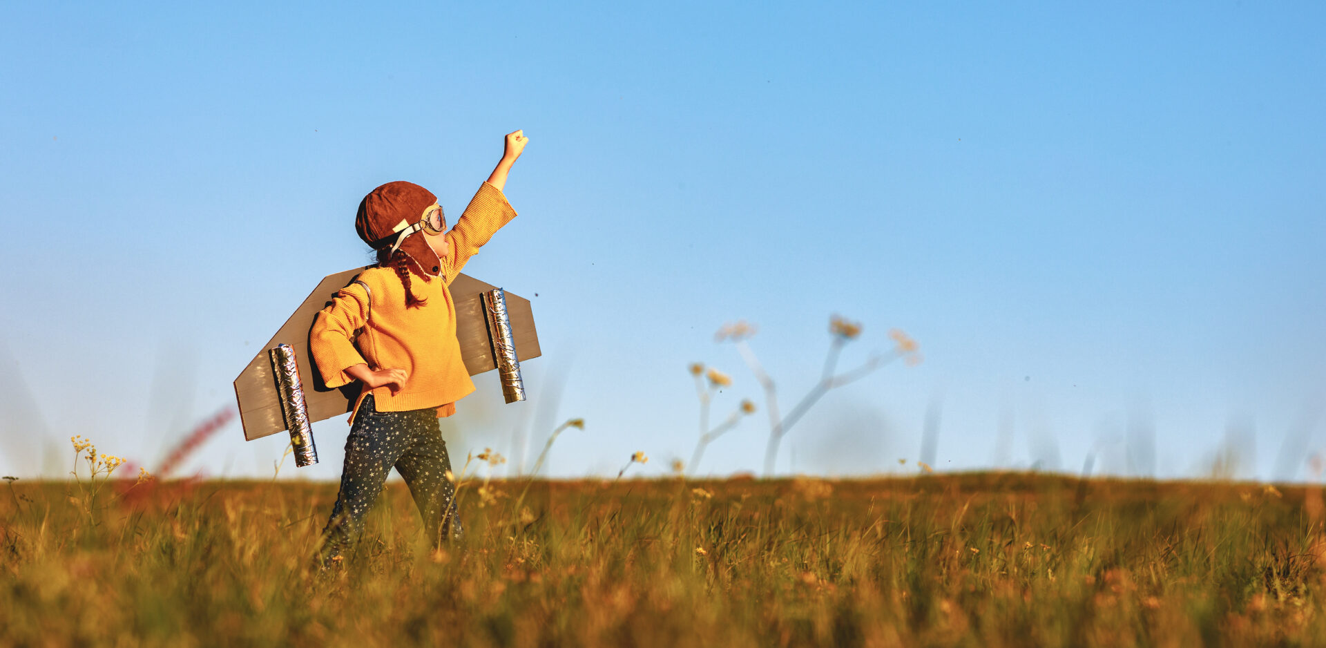 Boy pretending to fly with homemade rocket pack